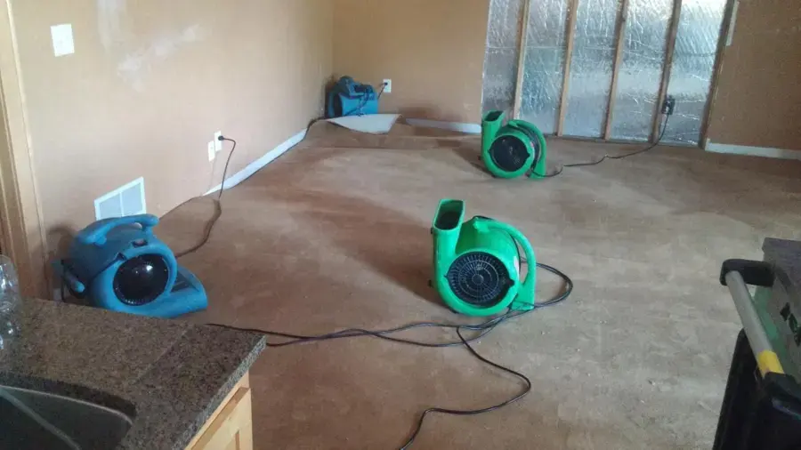 Air movers drying carpet in a Sugar Land home after a water loss