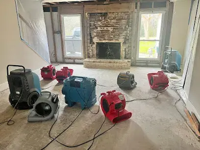 Air movers and dehumidifiers drying a Sugar Land living room after water damage