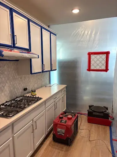 Kitchen sealed with plastic containment and a dehumidifier running